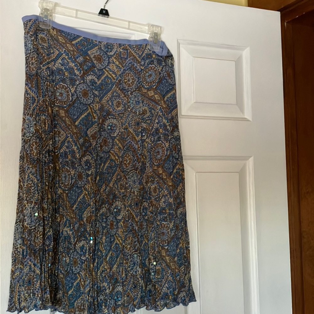Slightly below knee length, fully lined pinch pleat skirt.